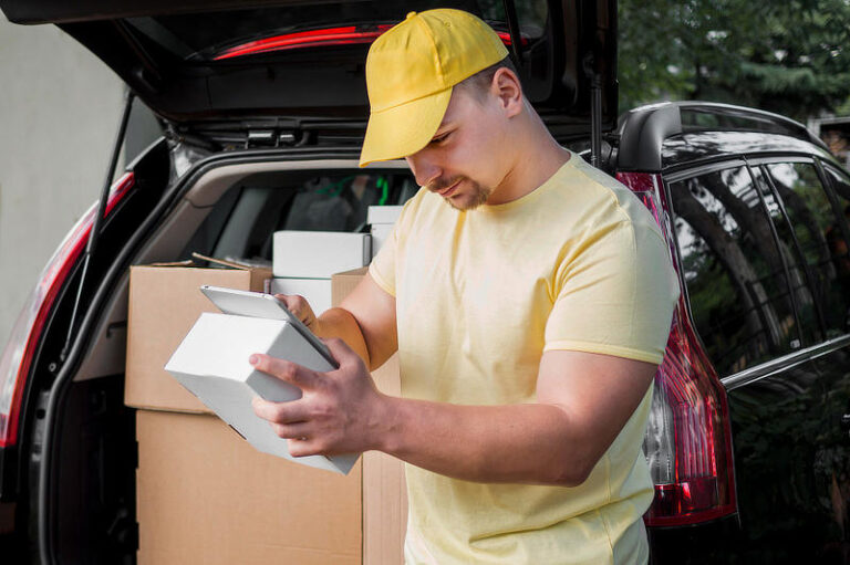 Delivery man with box and tablet.