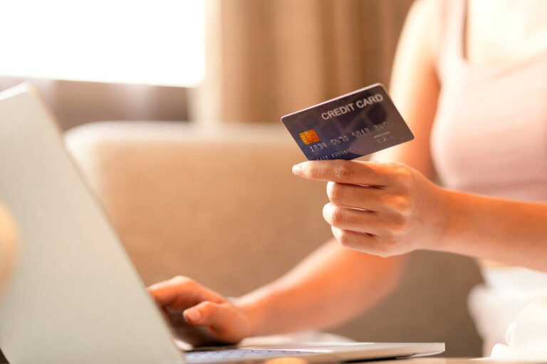 Female hands holding credit card.